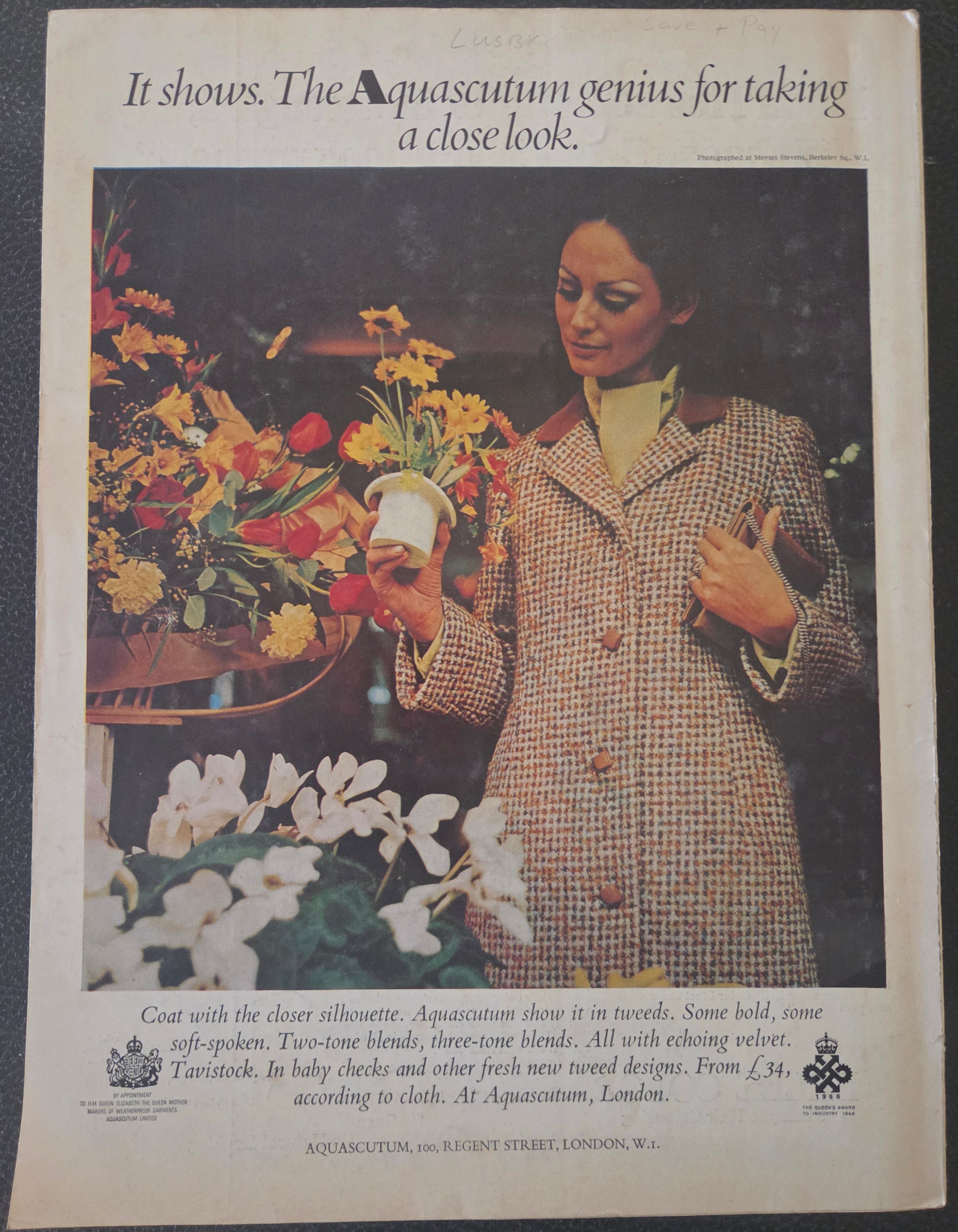 Vintage magazine advertisement featuring a woman with flowers and text about Aquascutum clothing.