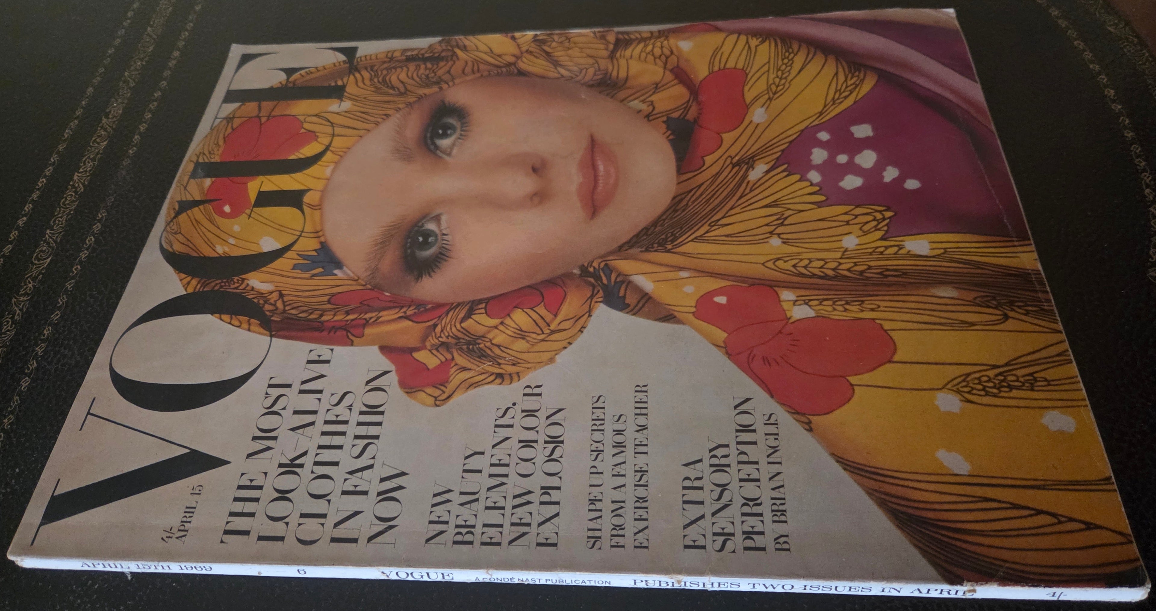 Vogue featuring model in golden headscarf.