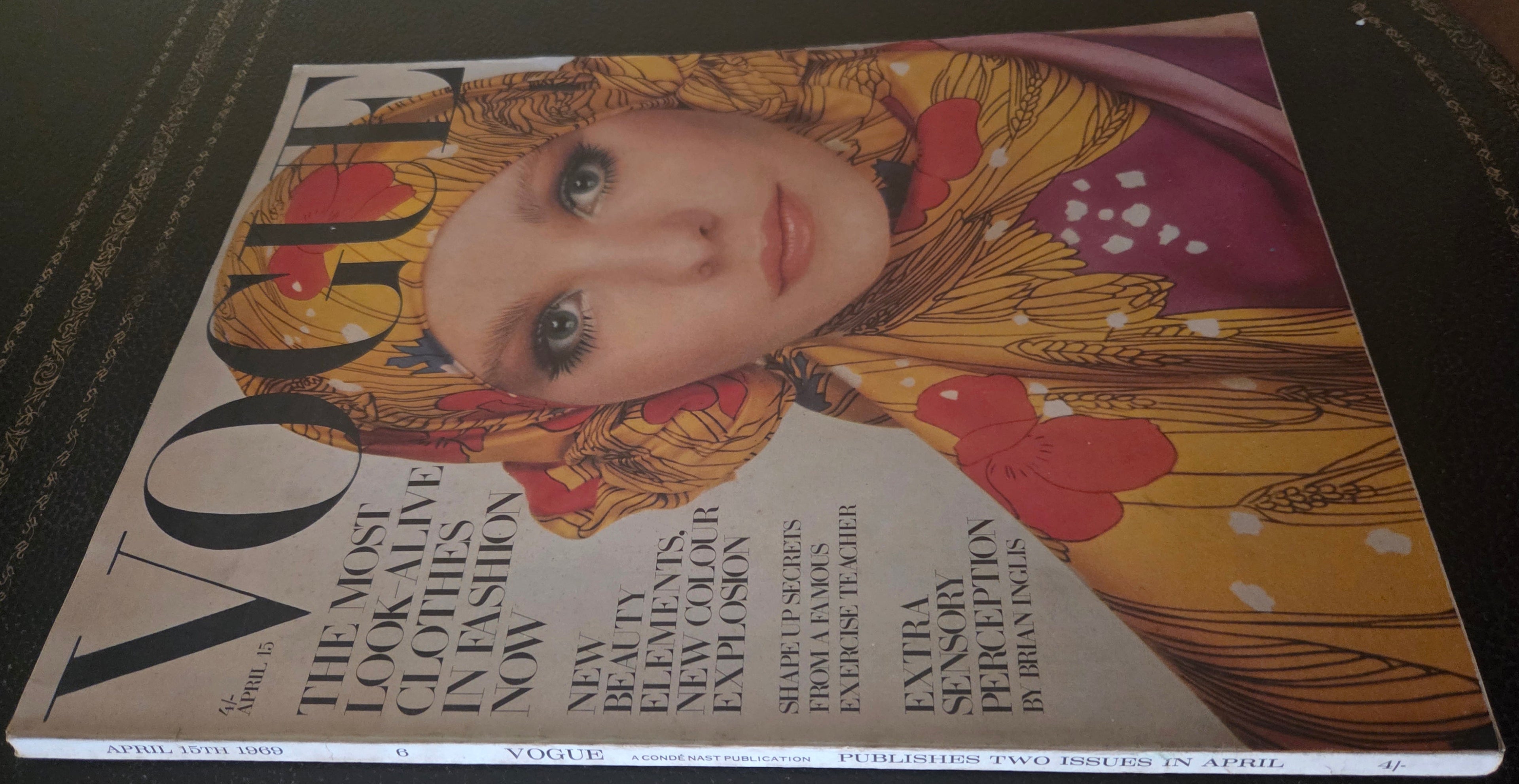 Vogue with model in golden headscarf.