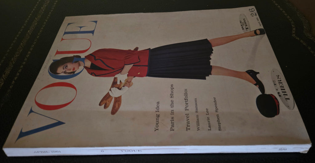 Vintage Vogue magazine cover with a woman in a red coat and dark skirt