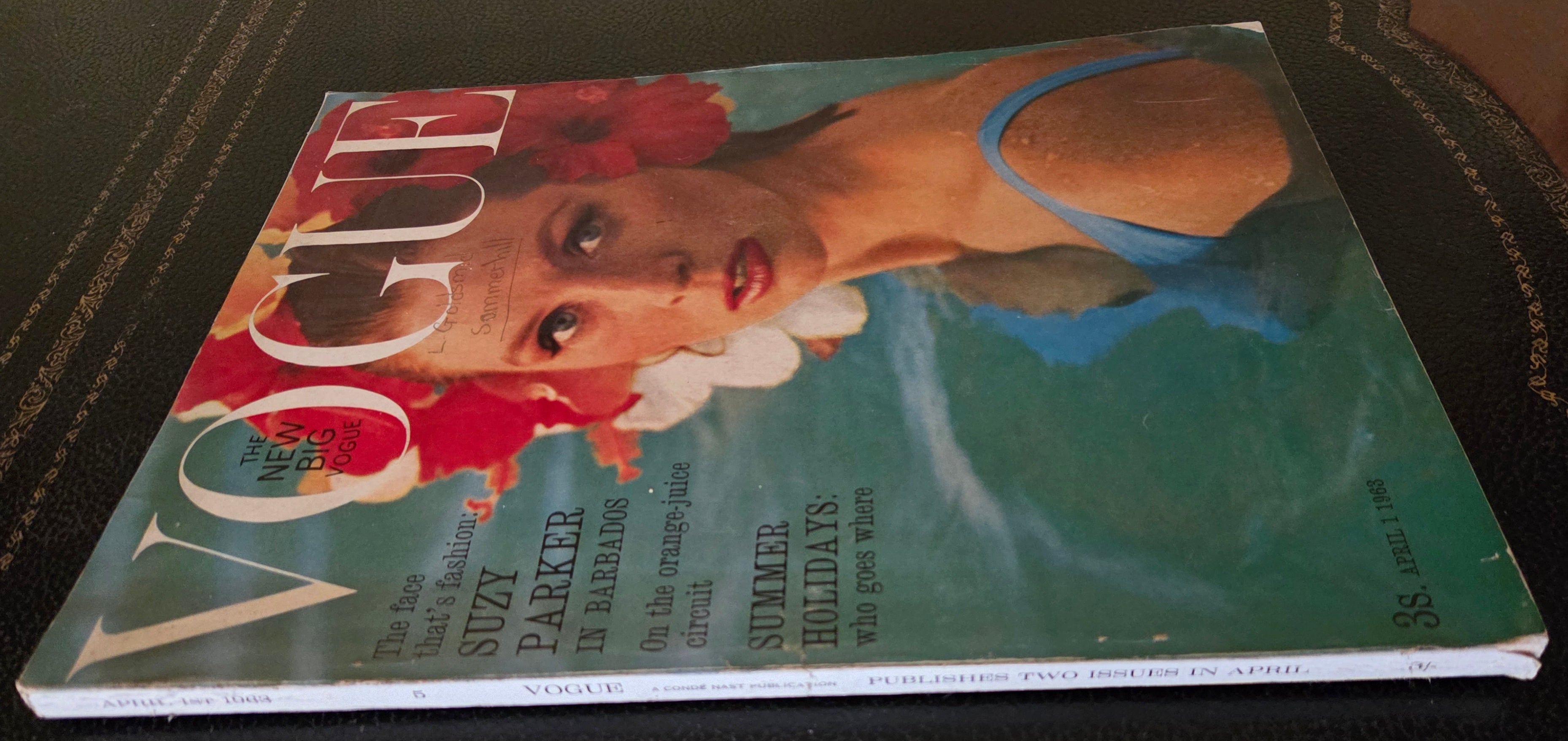 Vintage vogue with model in water and red flower headdress.