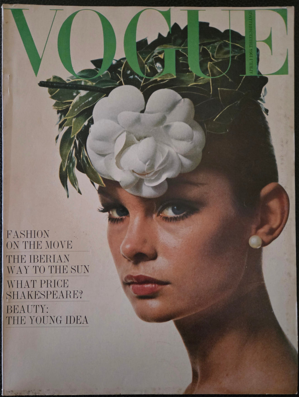 Vintage Vogue magazine cover with a woman's face and flower