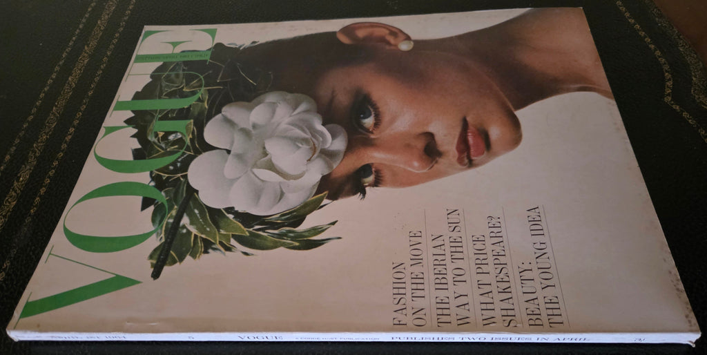 Vogue magazine cover with a woman's face and flowers 