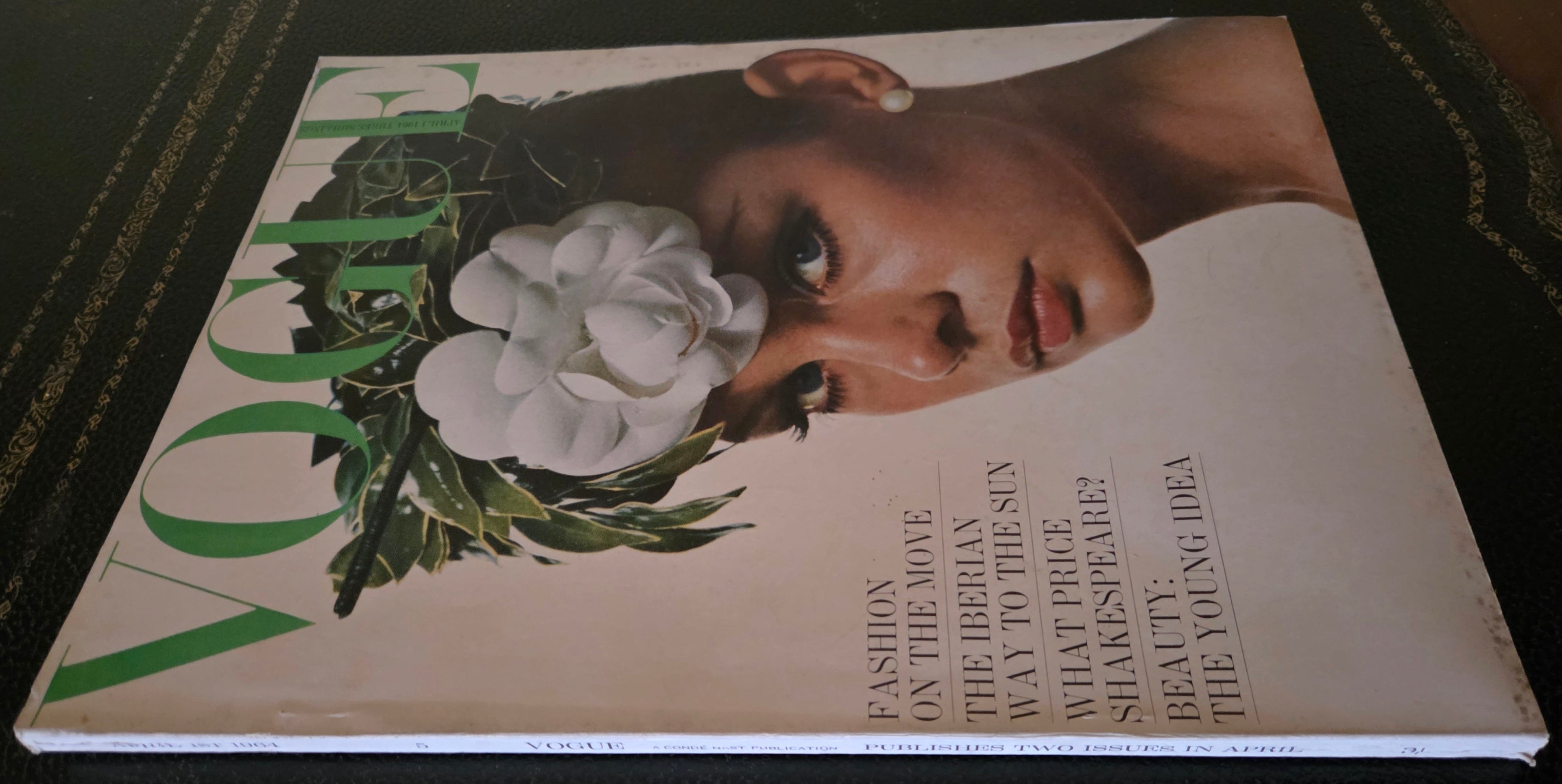Vogue magazine cover with a woman's face and flowers 