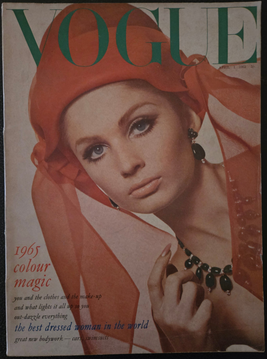 Vogue featuring model with orange hat and dark jewellery