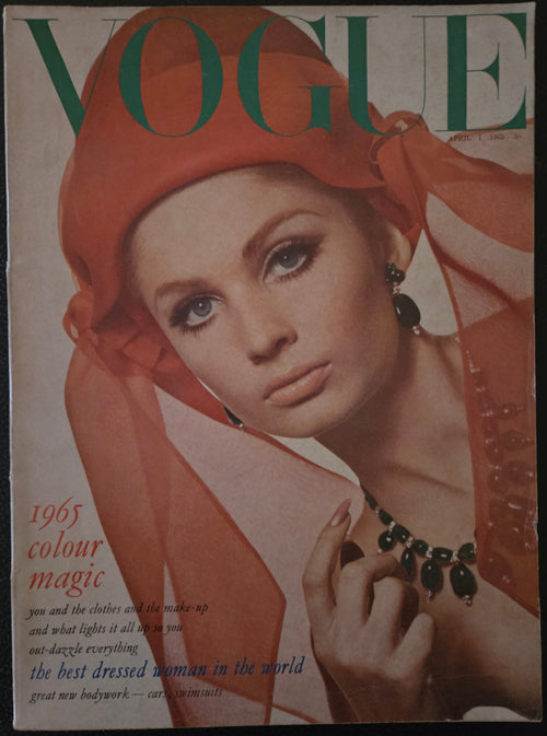 Vogue featuring model with orange hat and dark jewellery