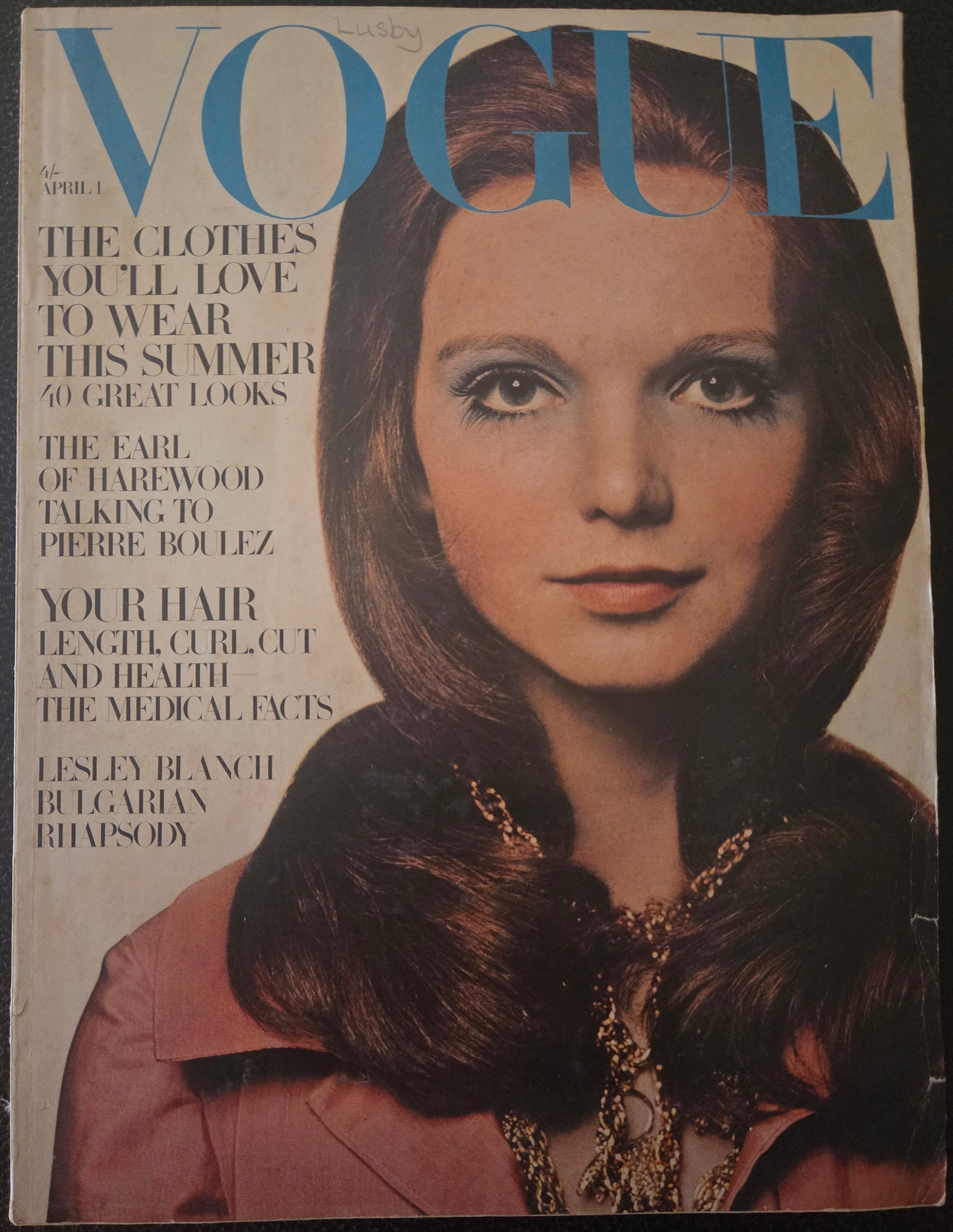 Vintage Vogue magazine cover with a woman's face and text