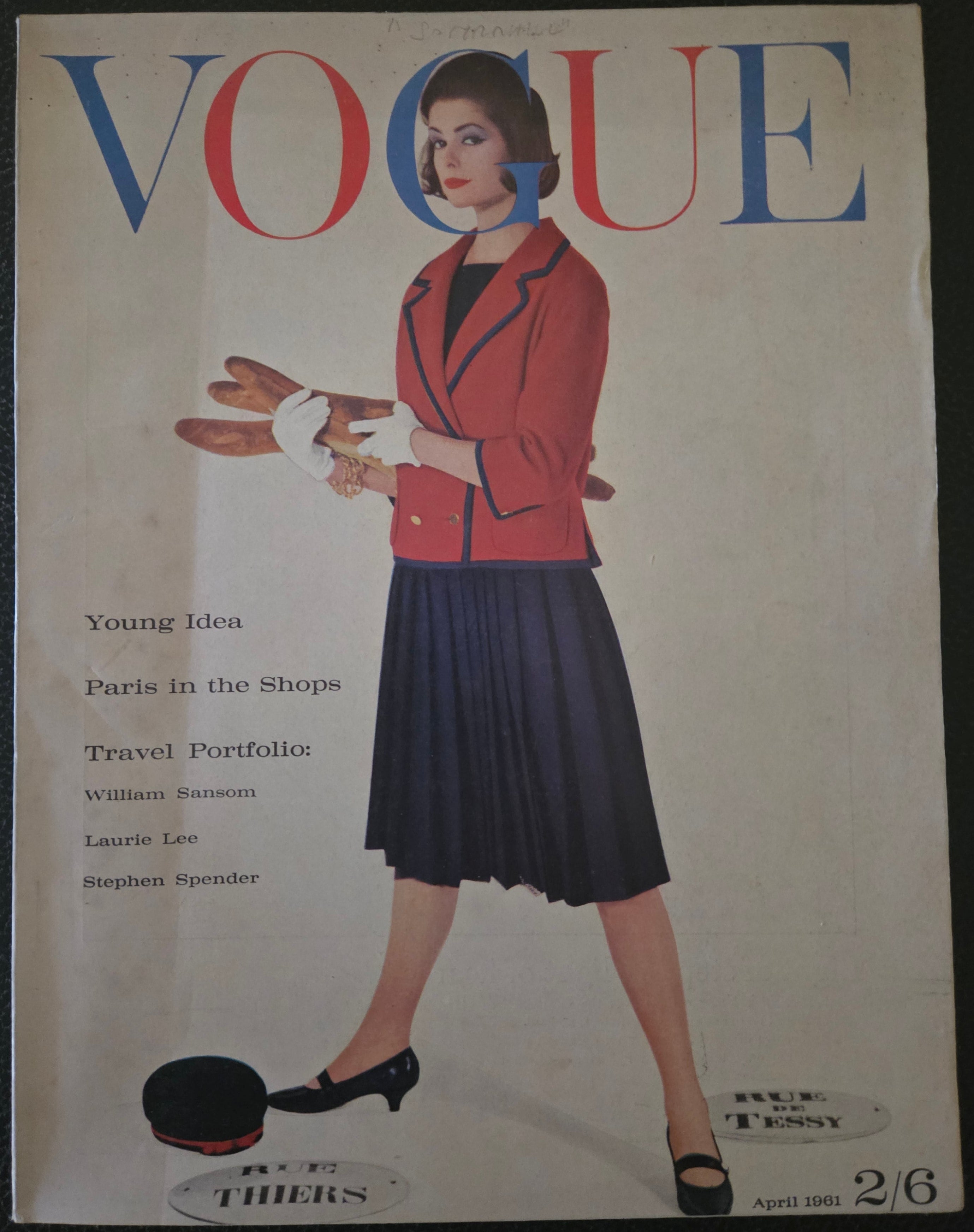 Vintage Vogue magazine cover with a woman in a red jacket and dark skirt.