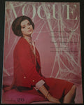 Vogue magazine cover with a model in a red outfit on a pink background