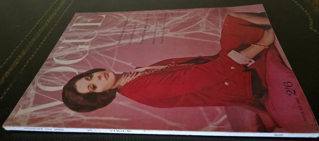 Vintage Vogue magazine cover with a woman in a red coat.