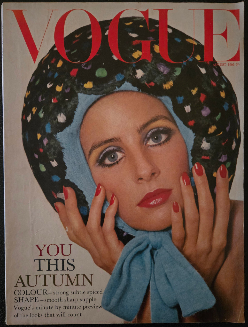 Vogue with model wearing multi coloured hat.