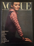 Vogue magazine cover with a model wearing a textured long-sleeve garment on a dark background