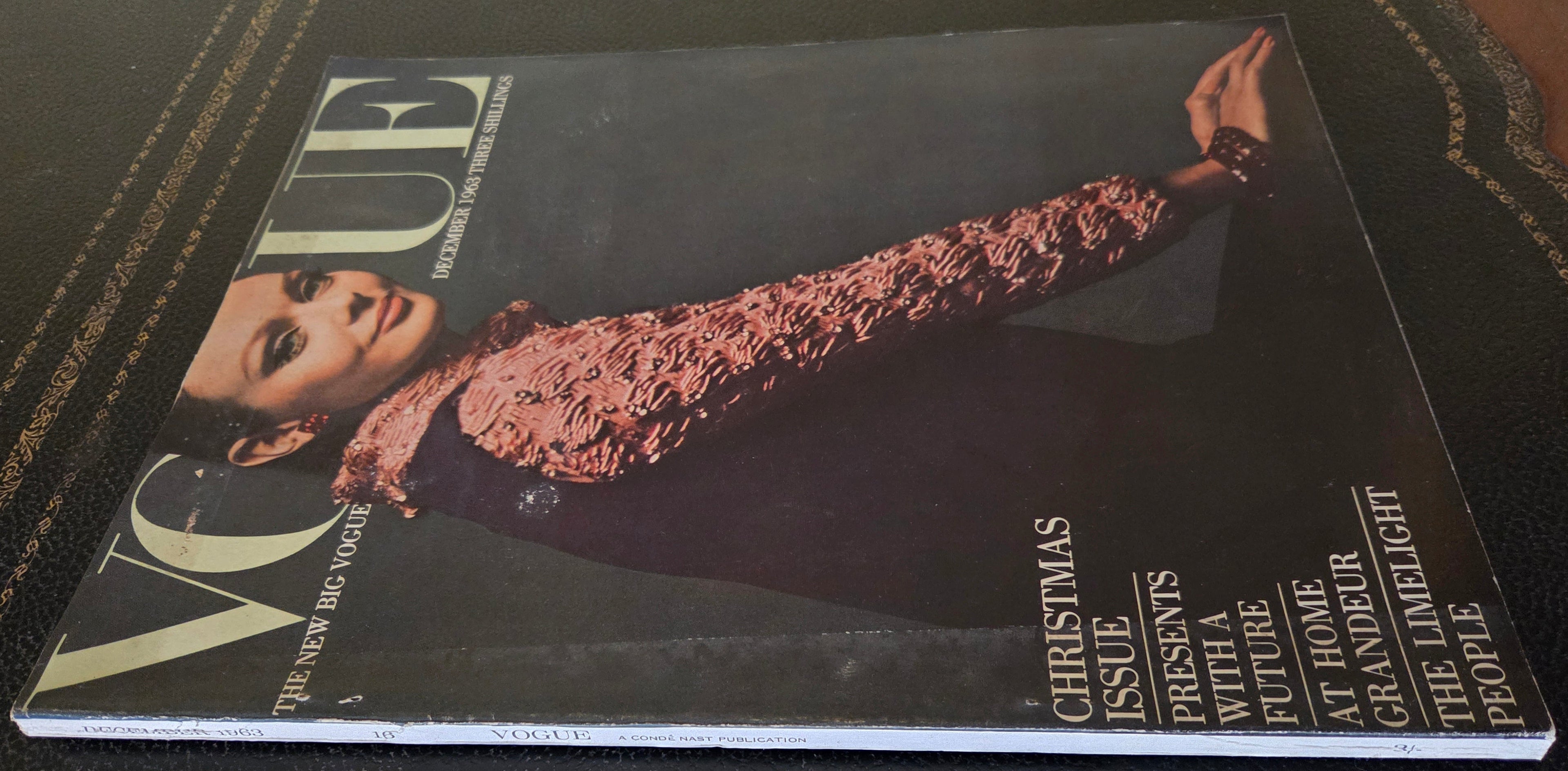 Vogue magazine cover with a model wearing a textured sleeve dress.