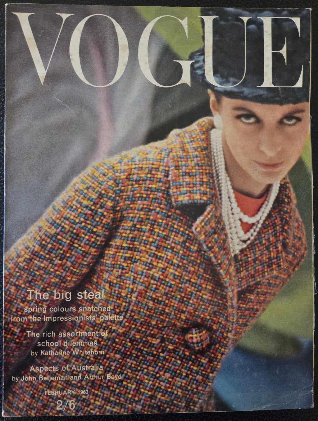 Vogue magazine cover featuring a model wearing a patterned coat.
