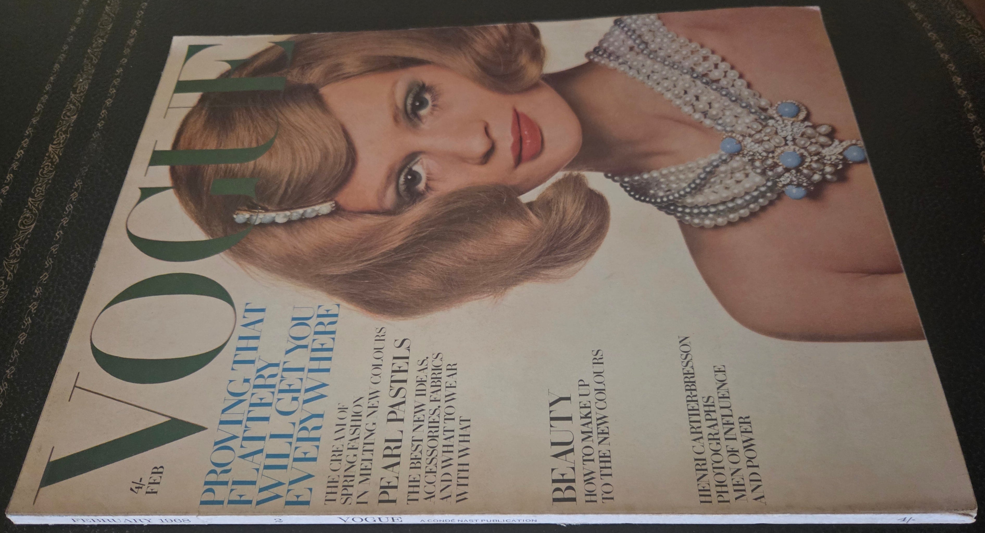 Vogue featuring model wearing pearl necklace