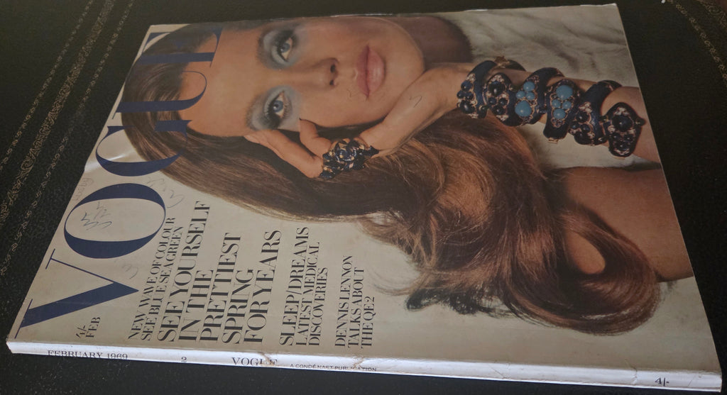 Vogue with model wearing blue jewellery.