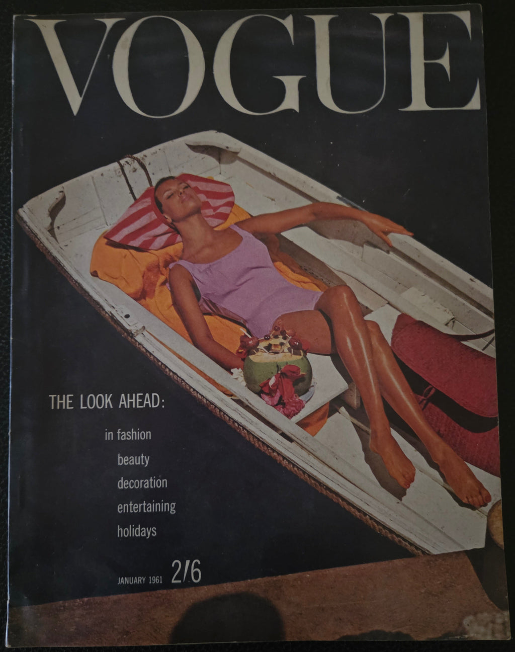 Vintage Vogue magazine cover with a woman on a boat