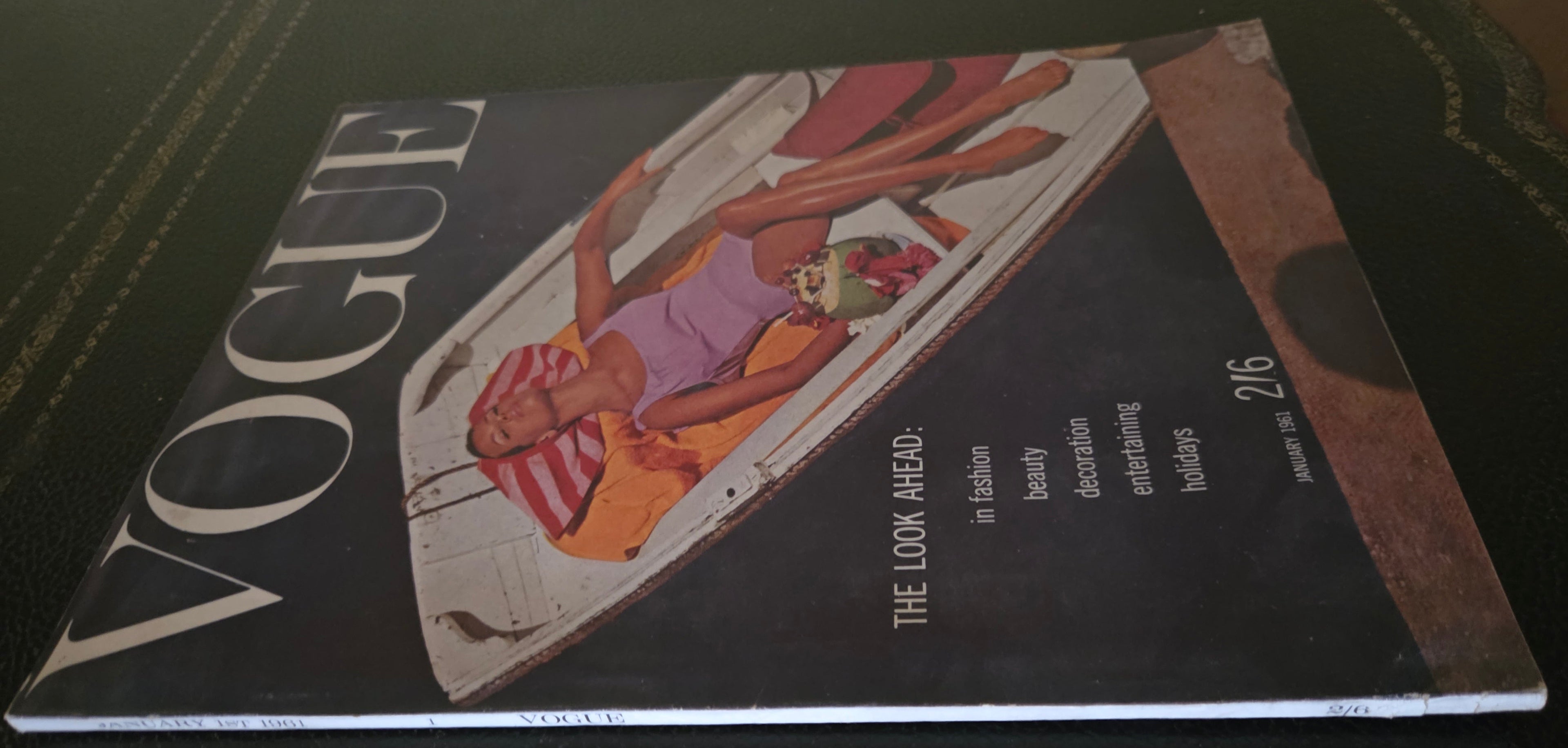 Vintage vogue with a model reclining in a boat.