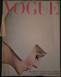 Vintage Vogue magazine cover with a woman wearing a white hat and the word 'Vogue' in pink.