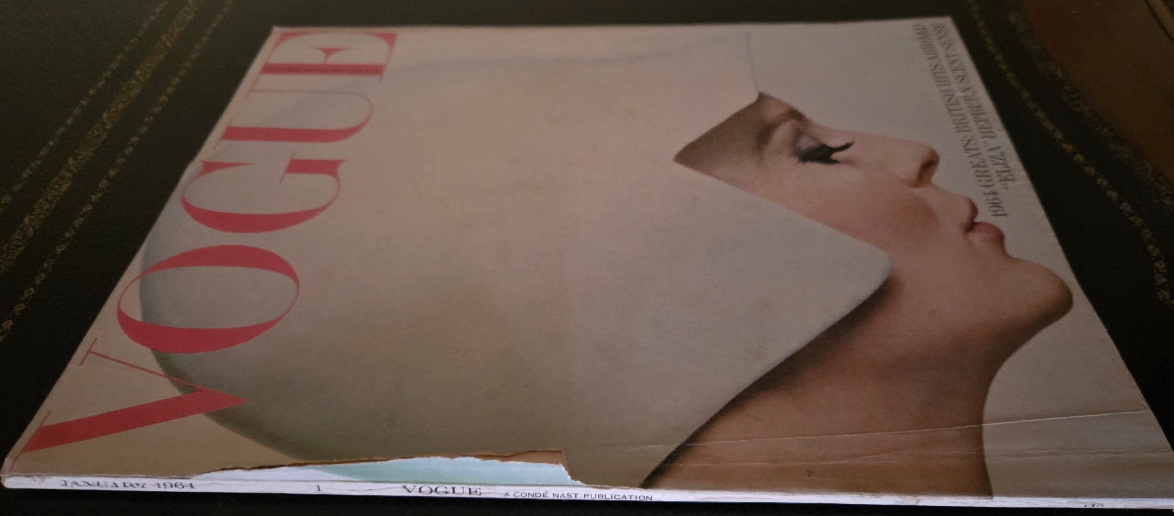 Vogue January 1964 with model in a white hat.