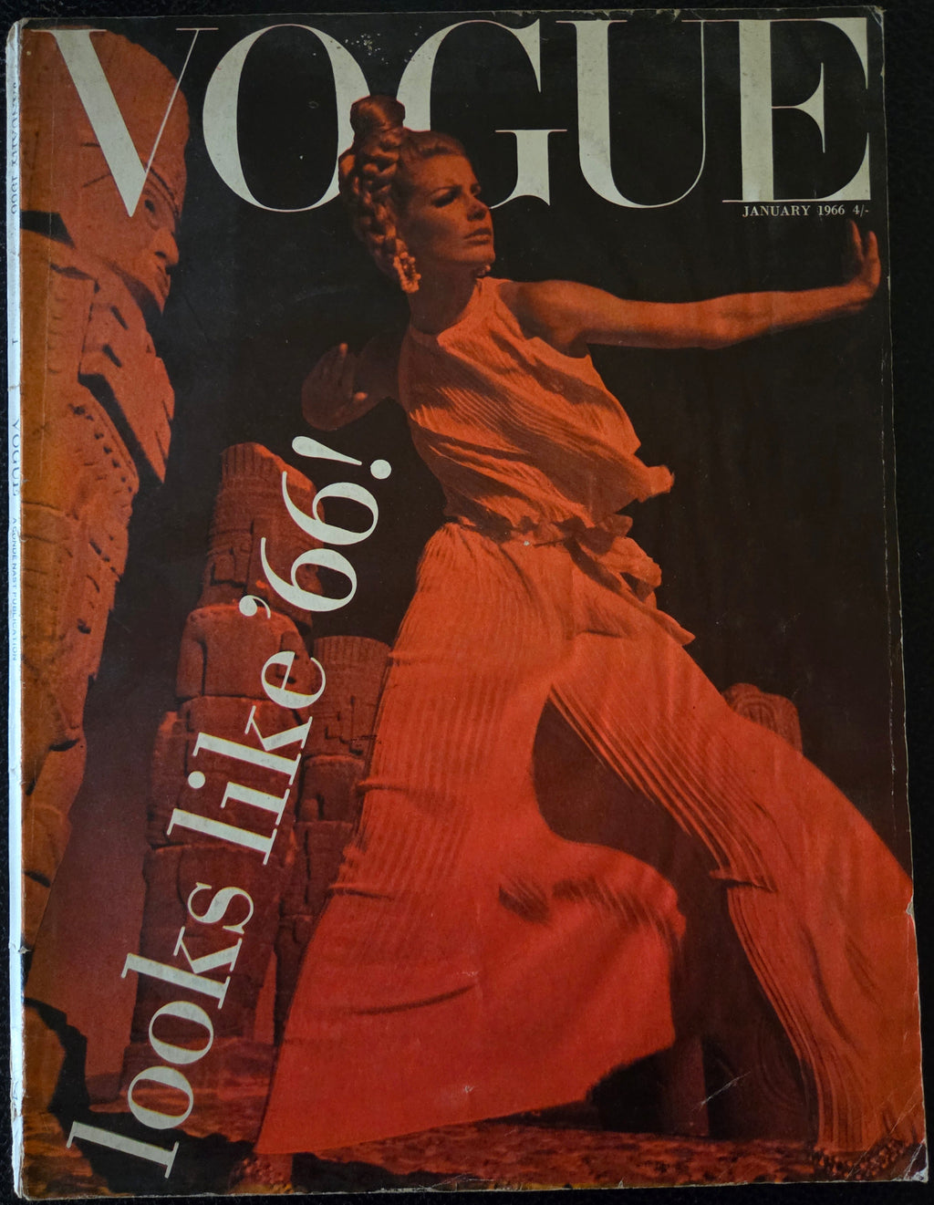 Vintage vogue with model with a red filter in front of ancient monuments.