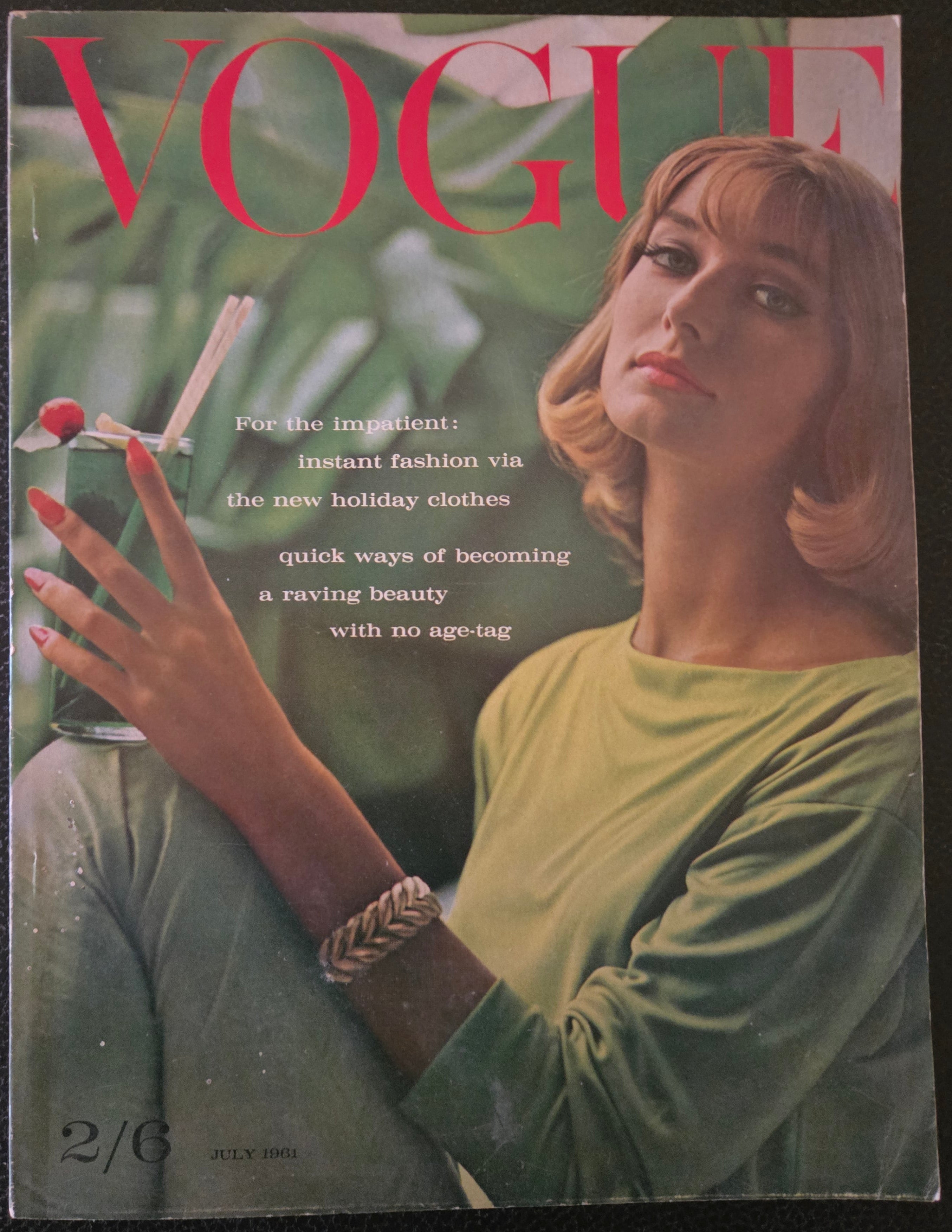 Vintage Vogue magazine cover with a woman holding a drink