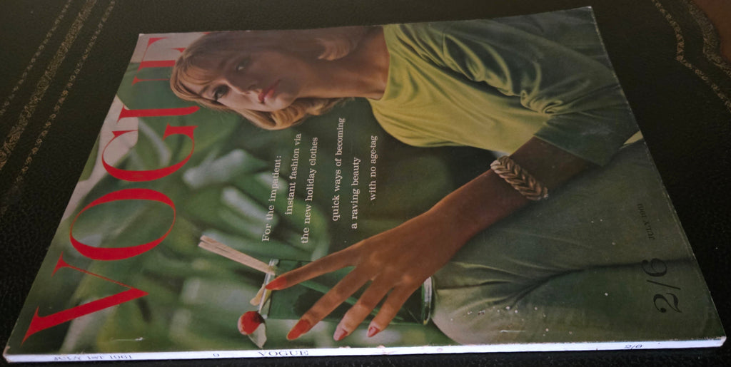 Vintage Vogue magazine cover with a model holding a drink