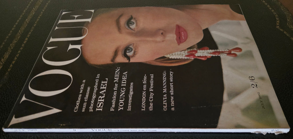 Vogue magazine with a cover featuring a model with jewelry