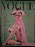 Vintage Vogue magazine cover with a model in a pink dress and hat on a green background