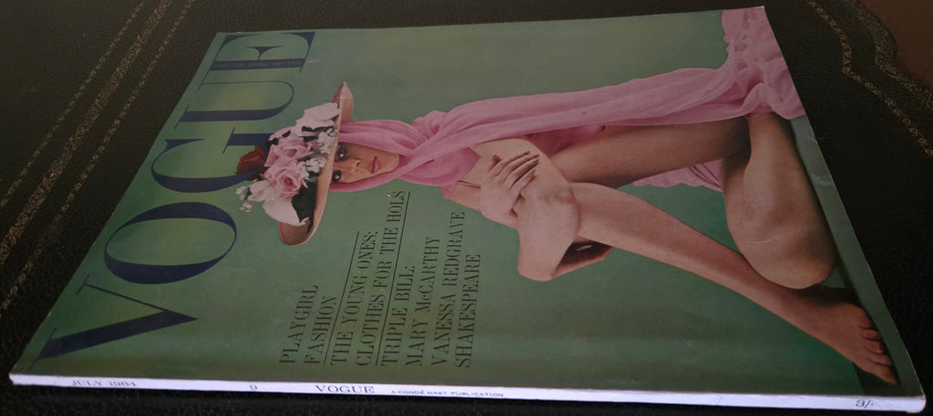 Vogue magazine cover with a model in a pink dress