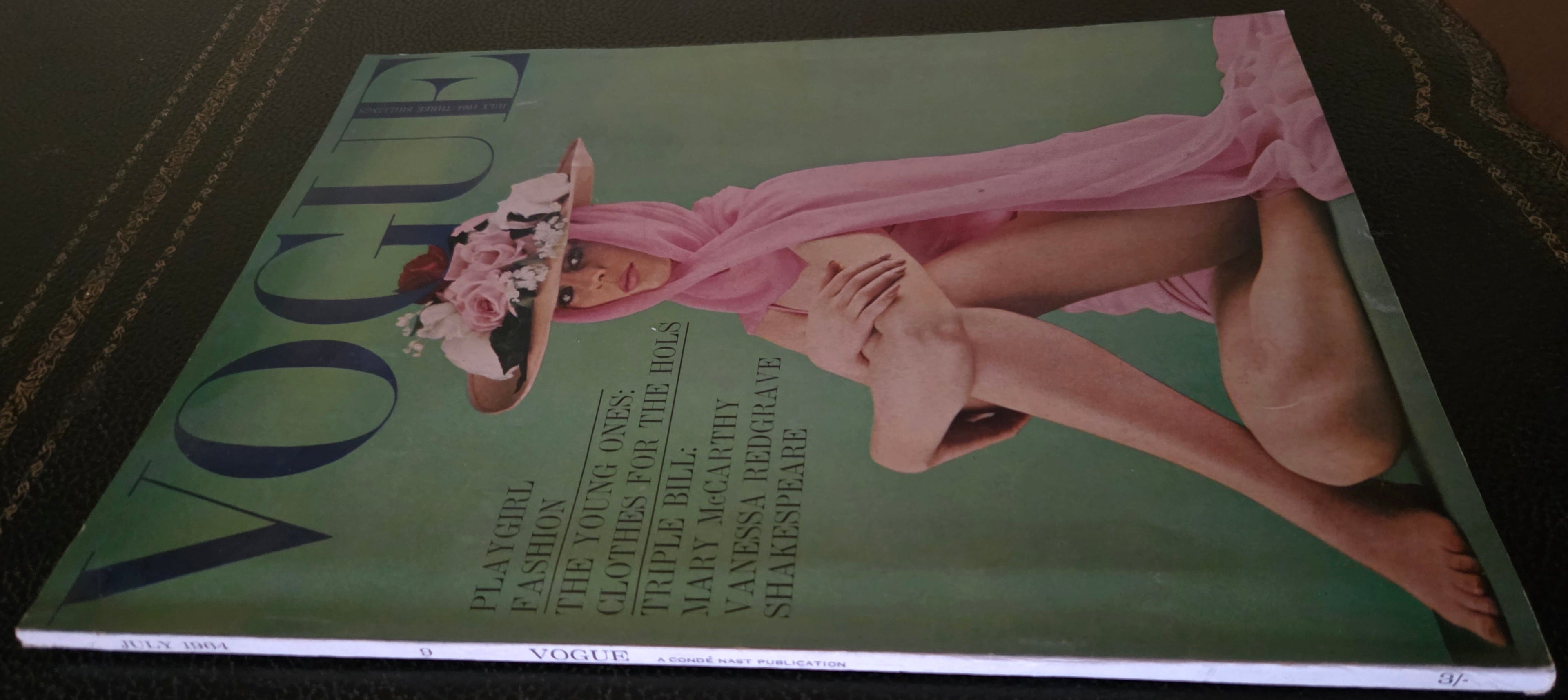 Vogue magazine cover with a model in a pink dress