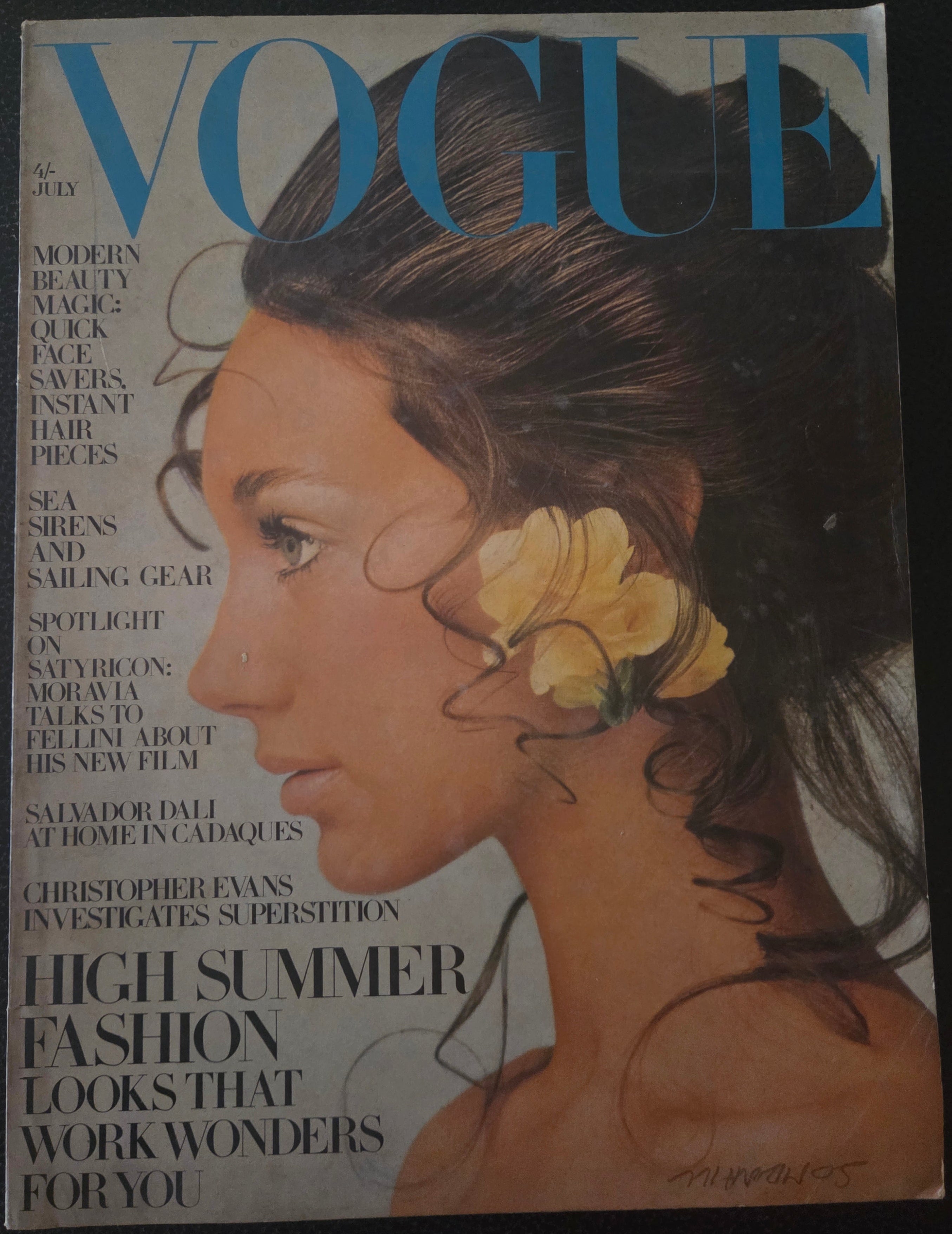 Vogue magazine with brunette model with yellow flower earring.