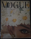 Vogue magazine cover with a woman's face and daisies
