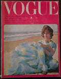 Vintage Vogue magazine cover with a woman in a blue dress on a beach