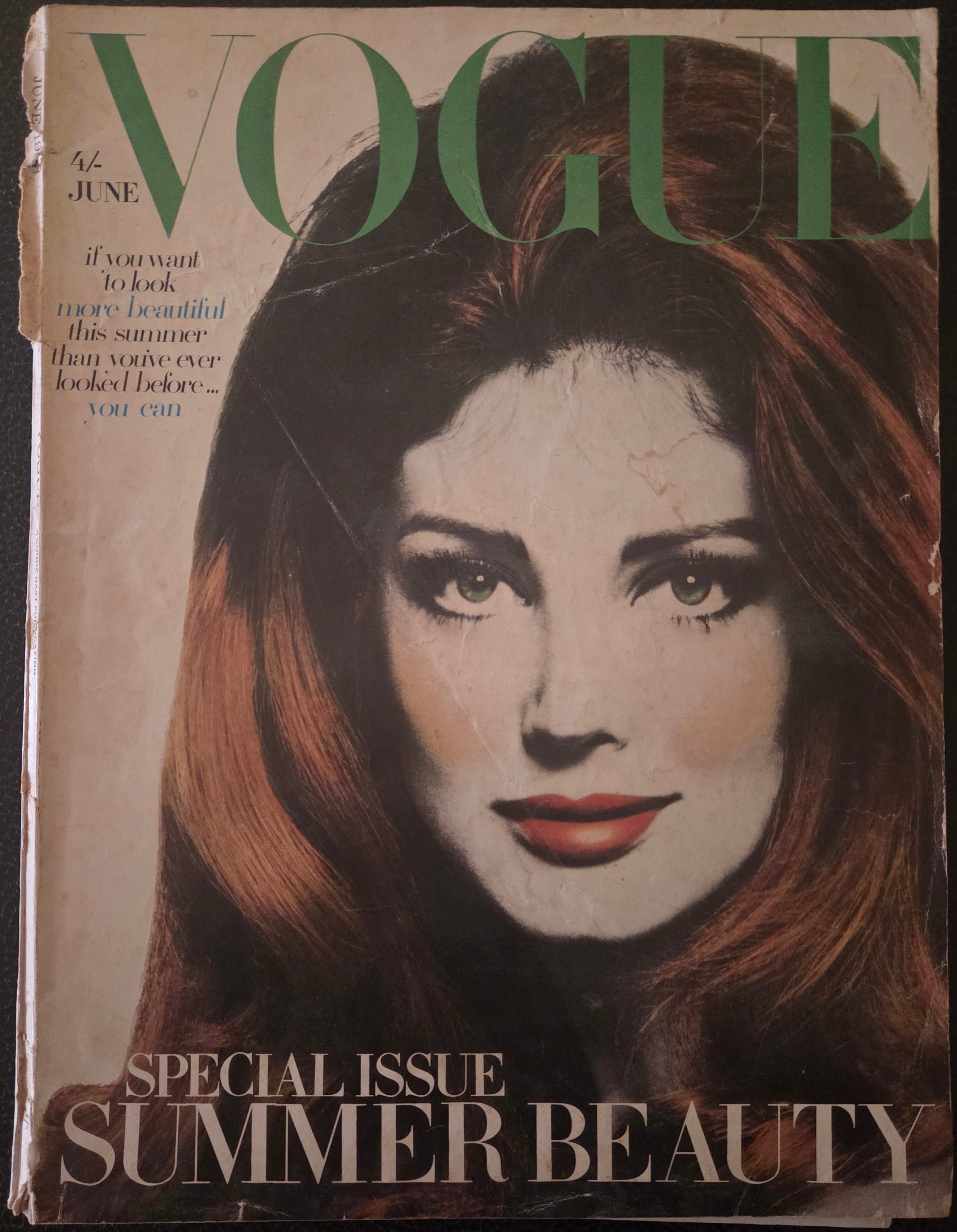 Vintage Vogue magazine cover with a woman's face on the cover