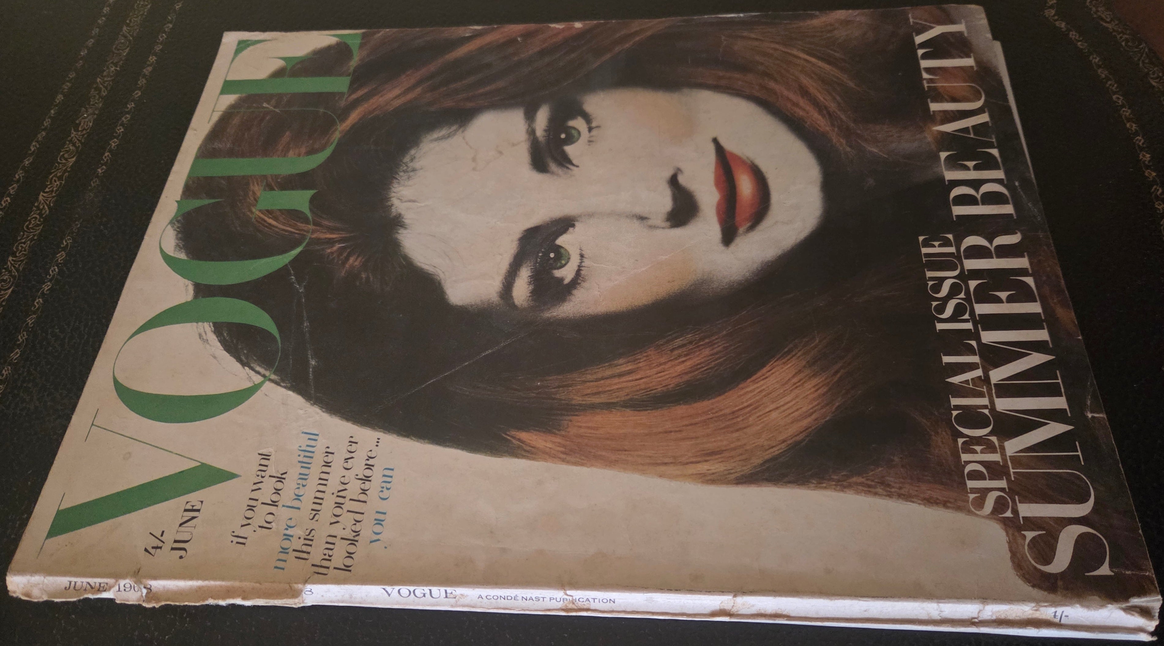 Vintage Vogue magazine with a woman's face on the cover