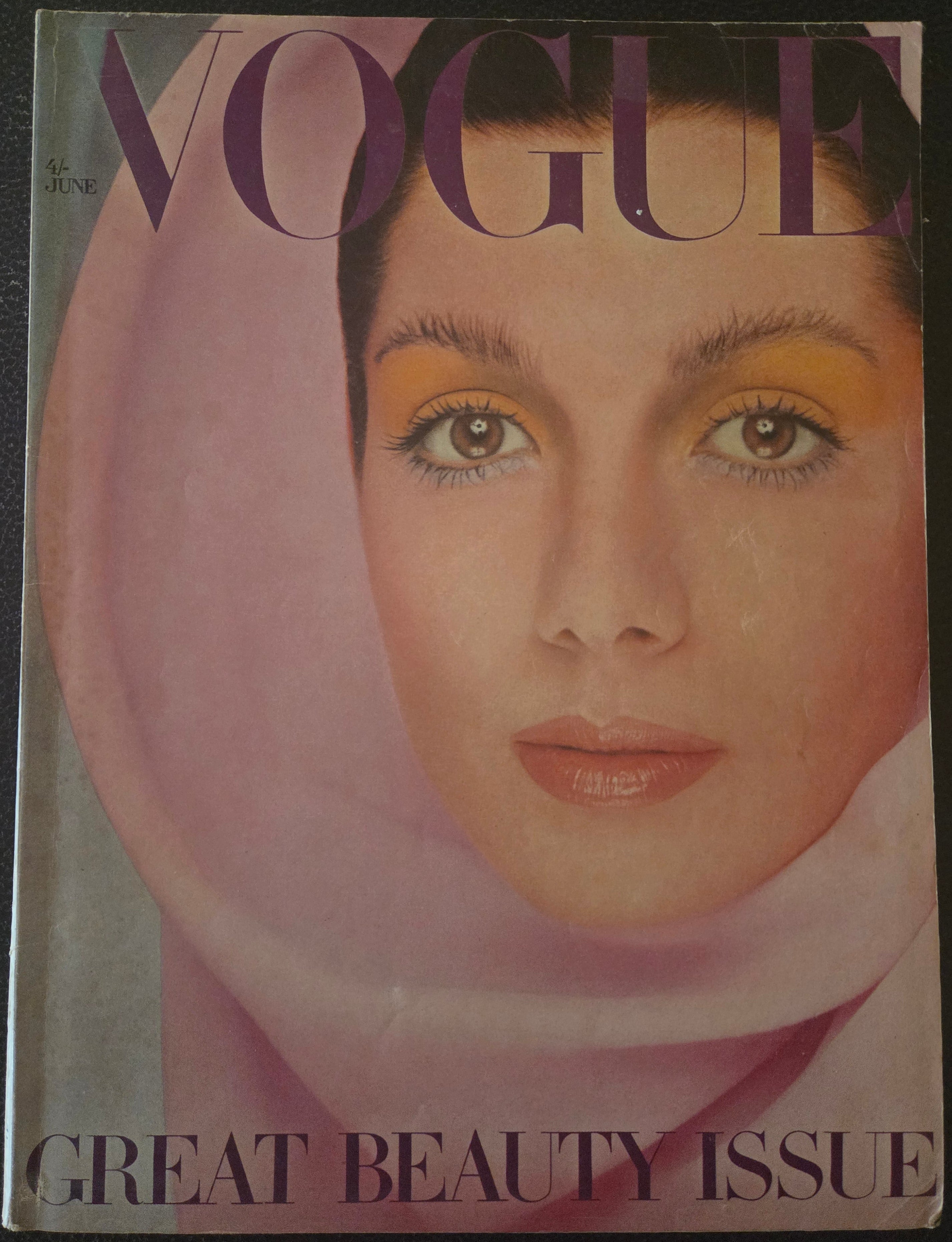 Vogue magazine cover with a close-up of a woman's face, featuring the Vogue logo.