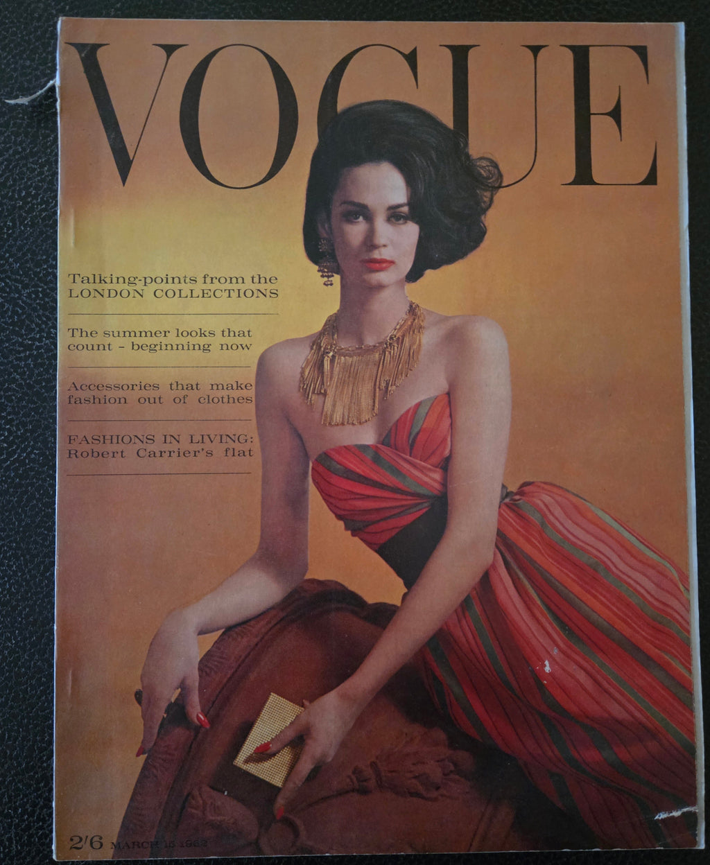 Vintage Vogue magazine cover with a model in a red dress 