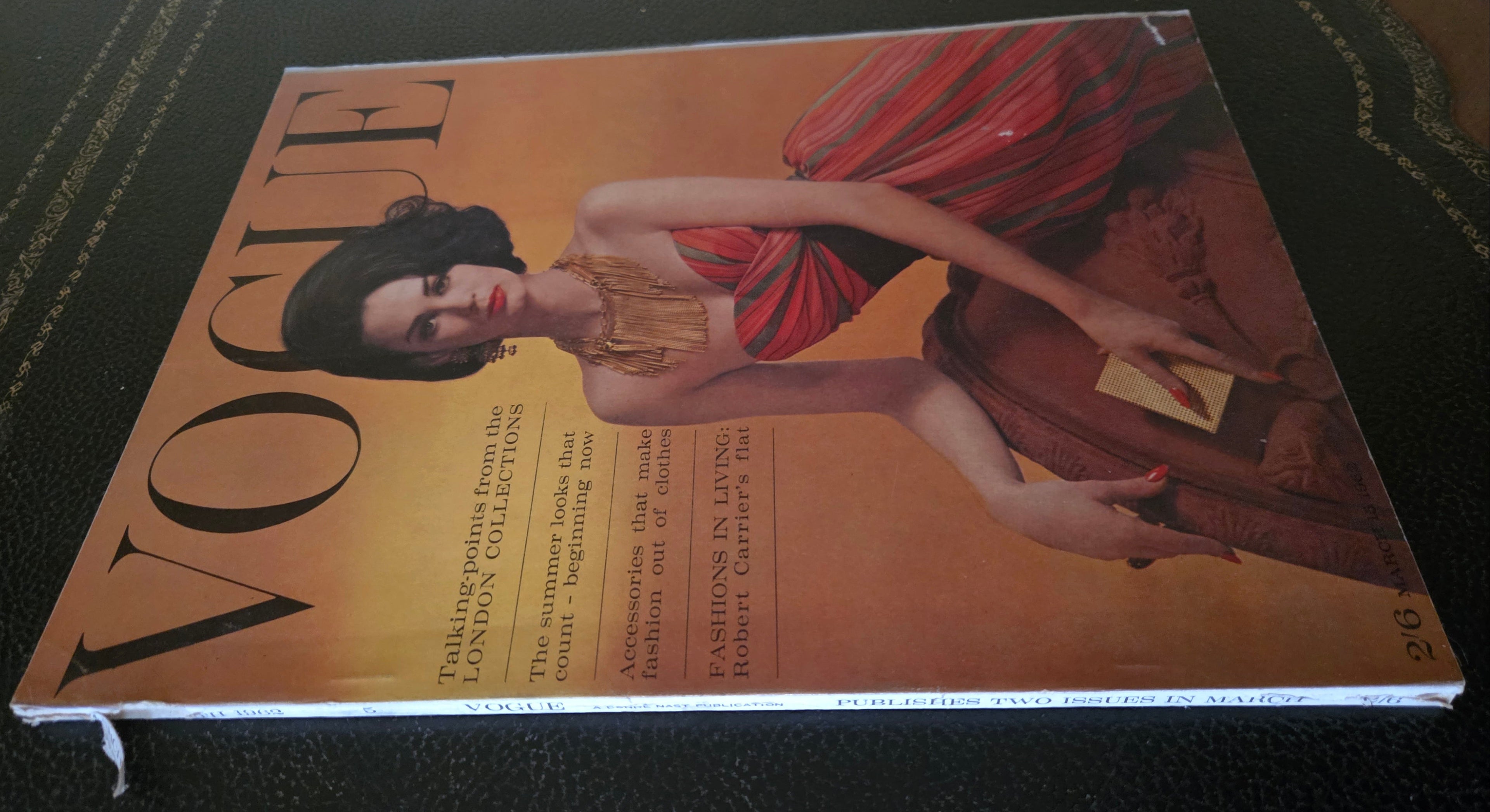 Vintage Vogue magazine cover with a model in a red dress