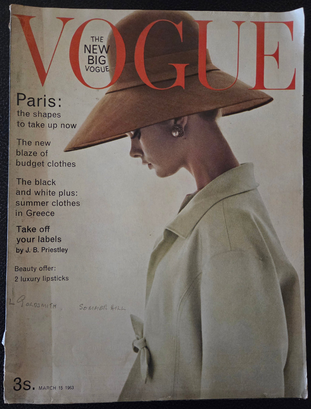 Vintage Vogue magazine cover with a woman wearing a large hat.