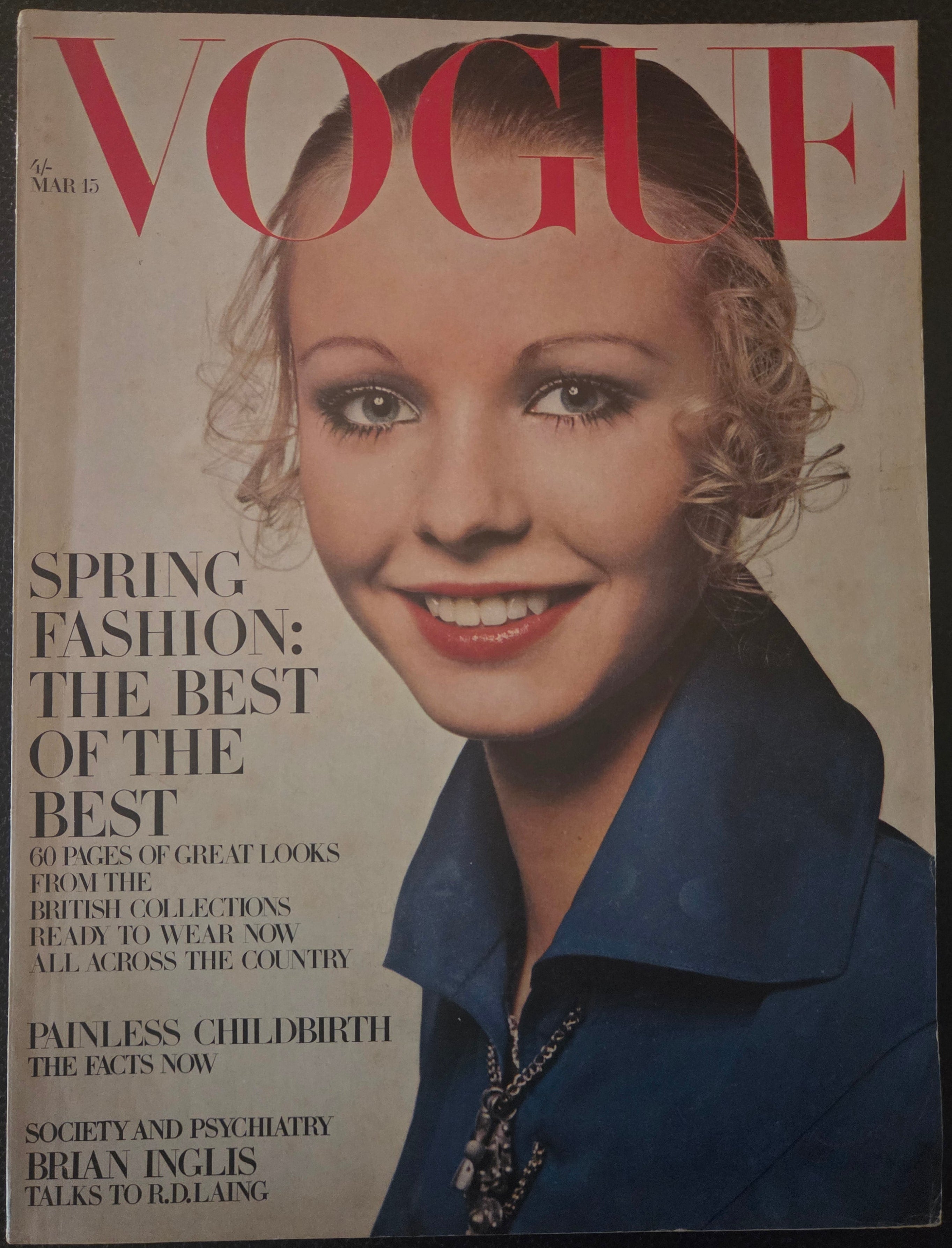 Vogue magazine cover with a woman's face and text.