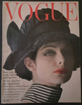 Vintage Vogue magazine cover with a stylized face and text