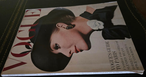 Vogue magazine featuring model with dark hat and floral scarf.