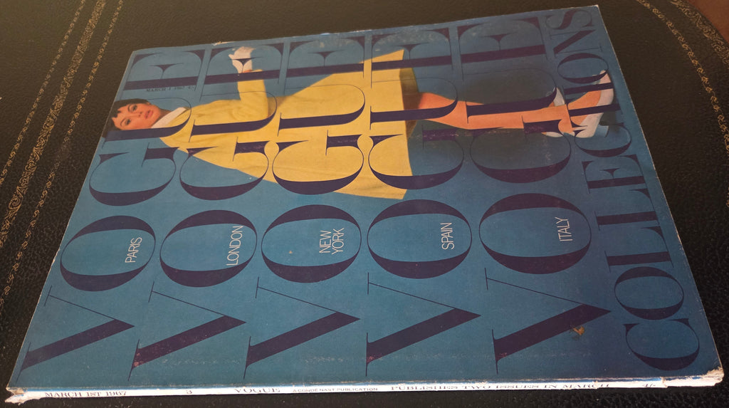 Vogue magazine with model in yellow outfit on blue ground