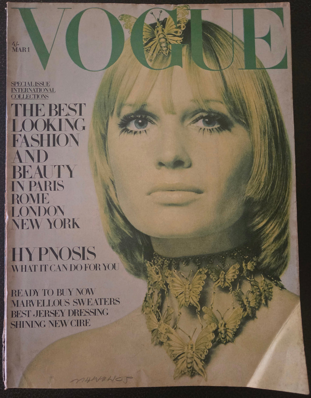 Vintage magazine cover with a woman's face and text about fashion and beauty.
