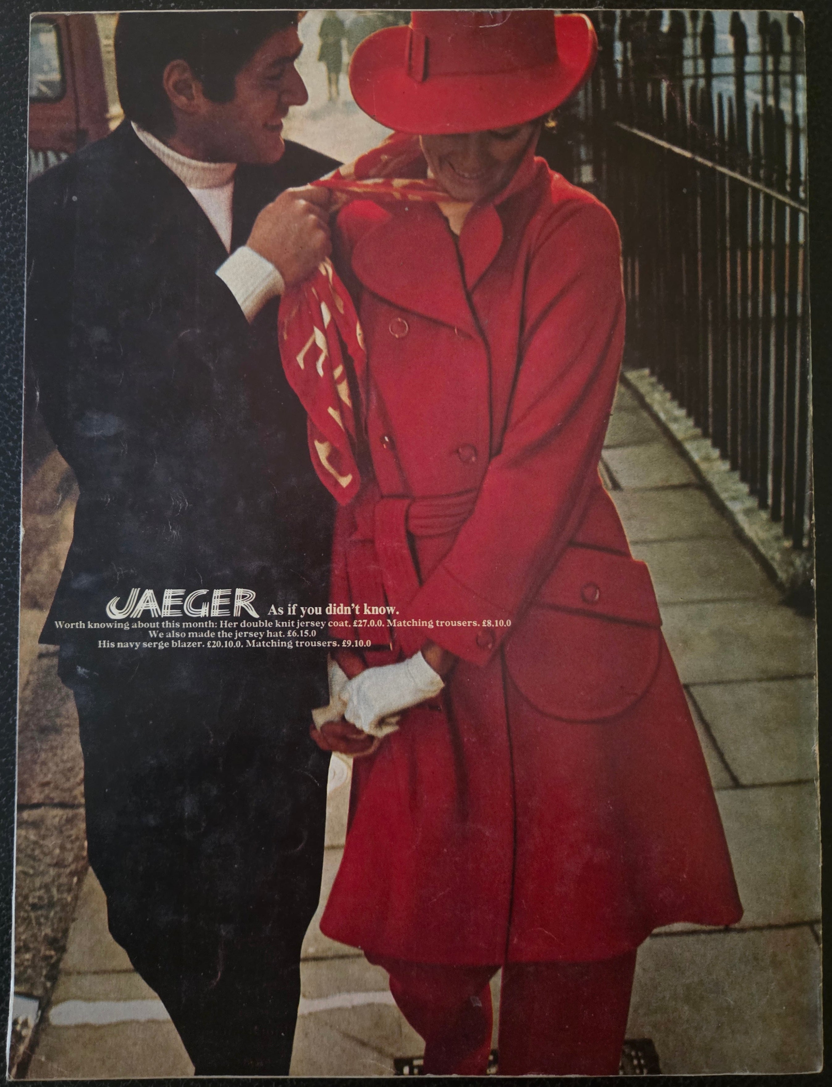Vintage advertisement featuring a woman in a red coat and hat, holding hands with a man, with 'Jaeger' branding.