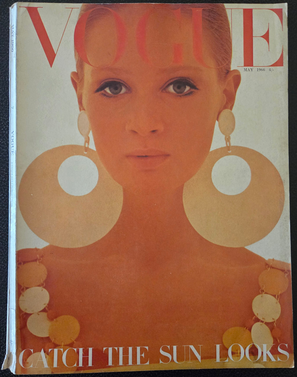 Vintage magazine cover with a stylized face and text 'Catch the Sun Looks'