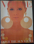 Vintage magazine cover with a woman's face and large circular earrings 