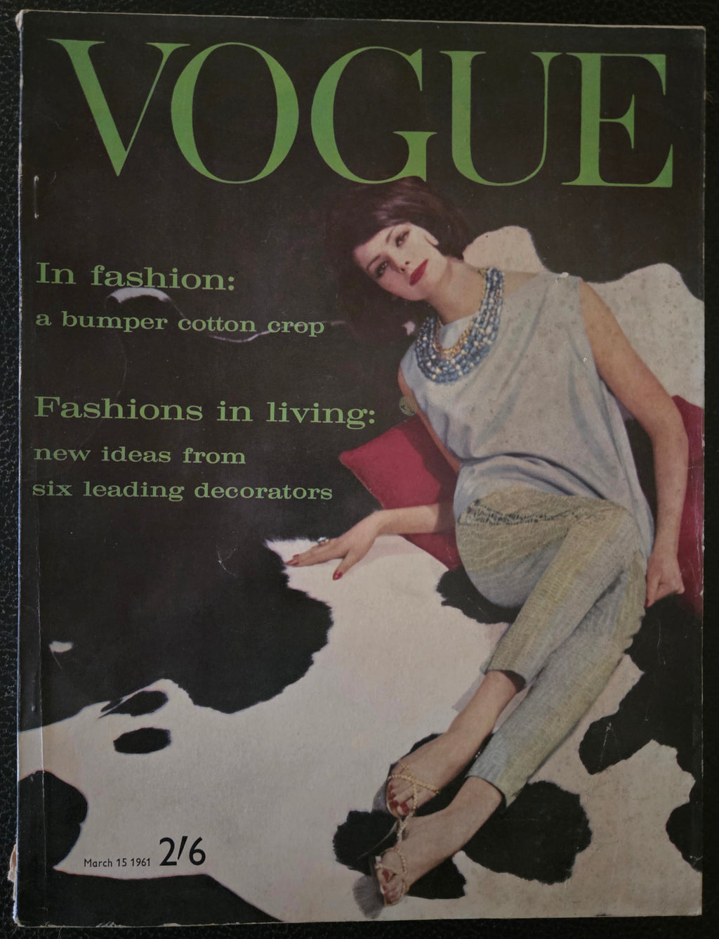 Vintage Vogue magazine cover with a model on a cow print background