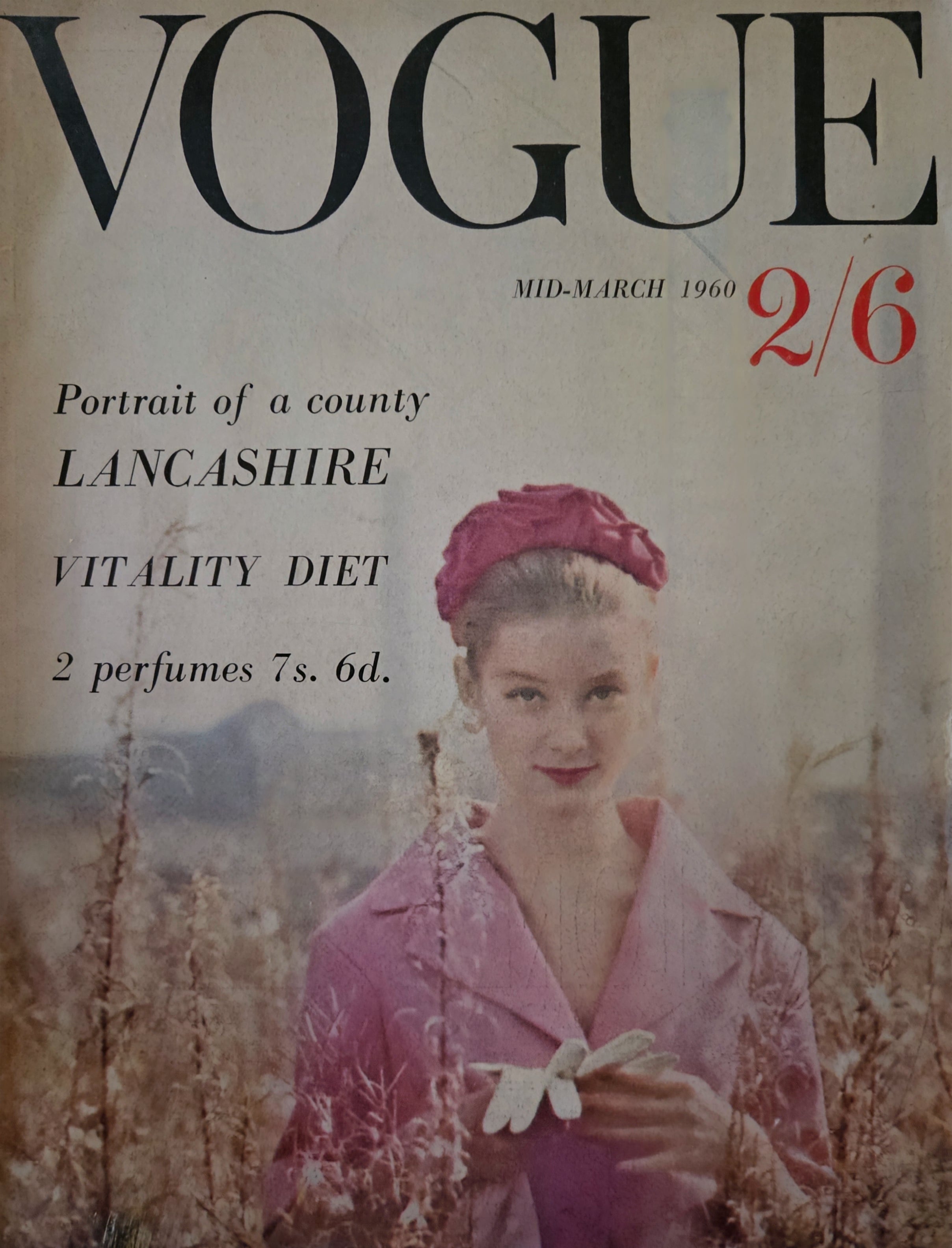 Vintage Vogue magazine cover from March 1960 with a woman in a pink outfit and headband.